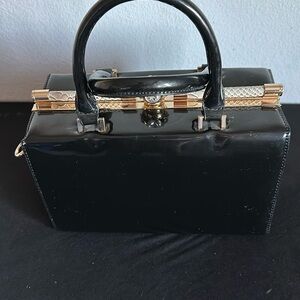 Black paten vintage square handbag with straps and crystal latch